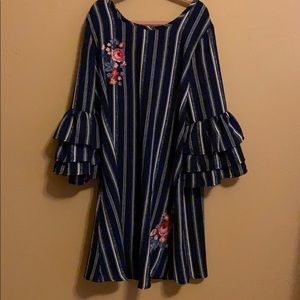 A navy and white long sleeve embroidered dress